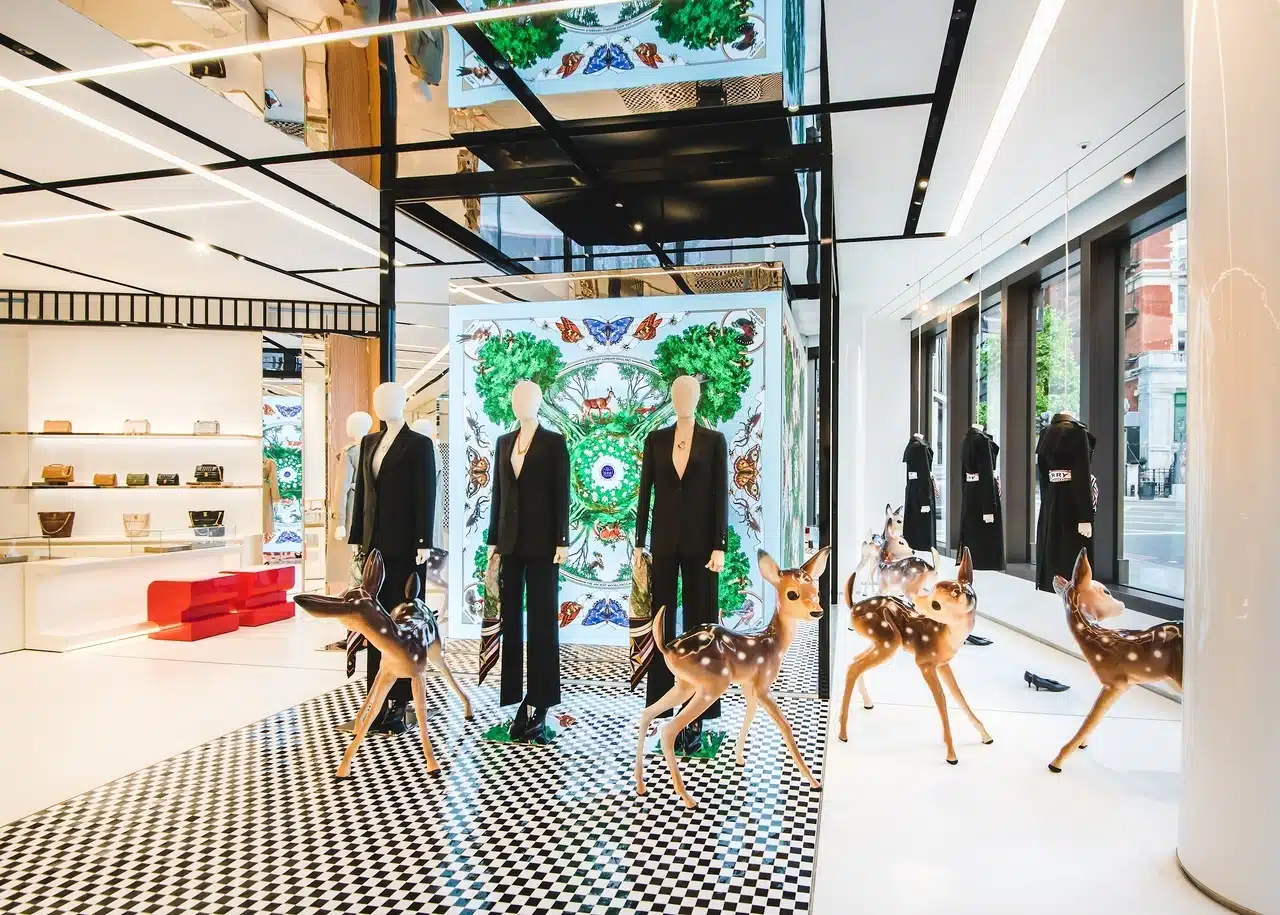 a fashion brands black and white flagship store with chequered floors and ceilings, mannequins and deer figures.