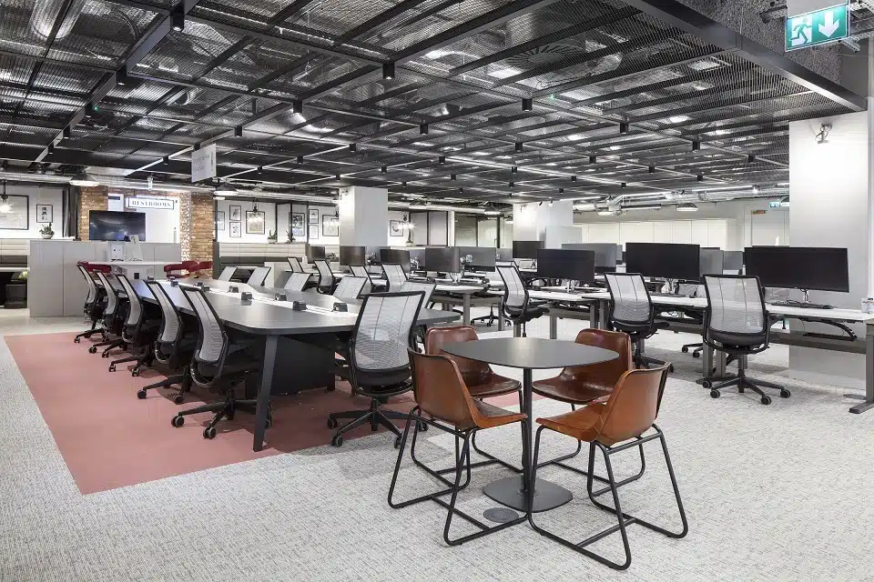 An image of an open-plan office without any people sitting at the desks.