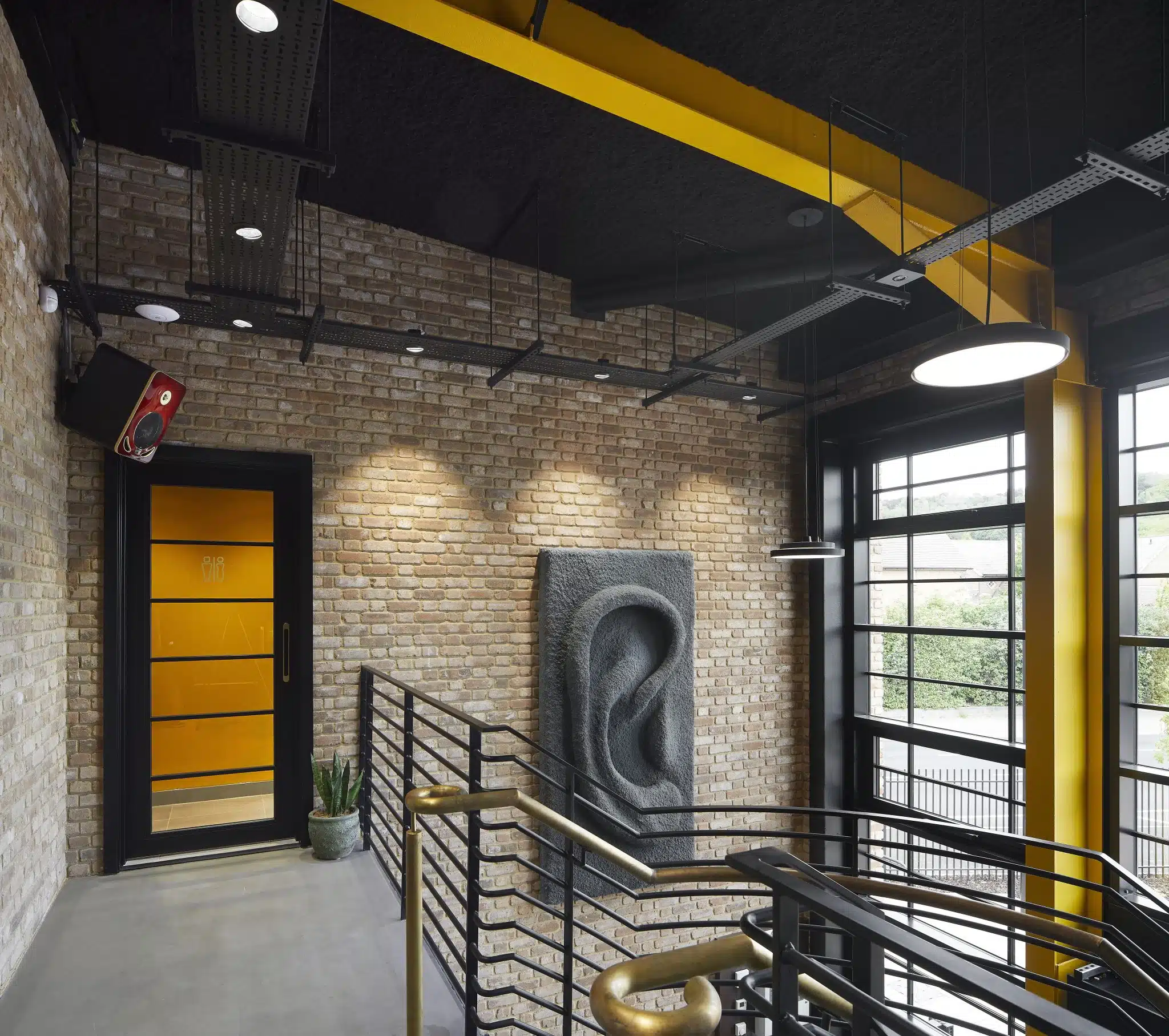 SonaSpray K-13 black acoustic ceiling spray in welcome lobby. ©Hufton+Crow