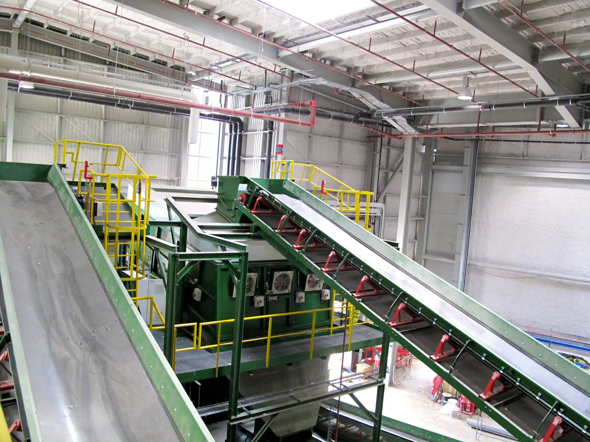 SonaSpray K-13 acoustic ceiling spray in grey to acoustically treat waste management facility.