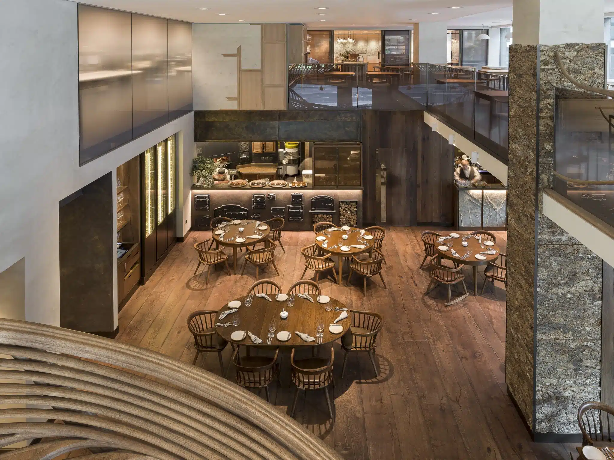 large open plan restaurant space with wooden floors and tables and chairs.