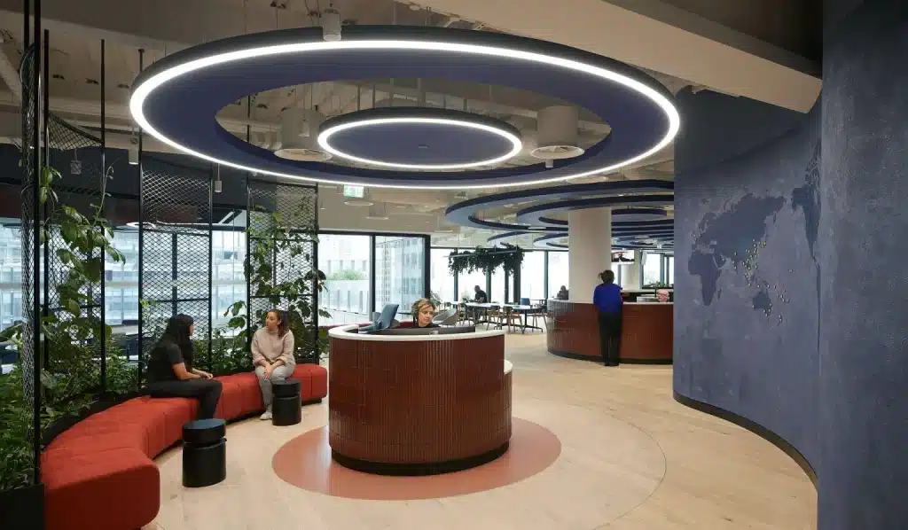 Modern office reception with circular lighting and seating area